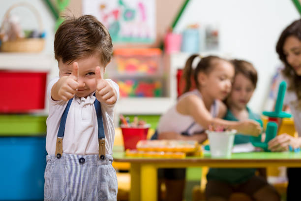 Happy little boy posing in classroom.