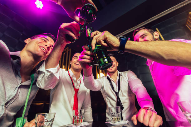 Group of smiling male friends having fun in night club